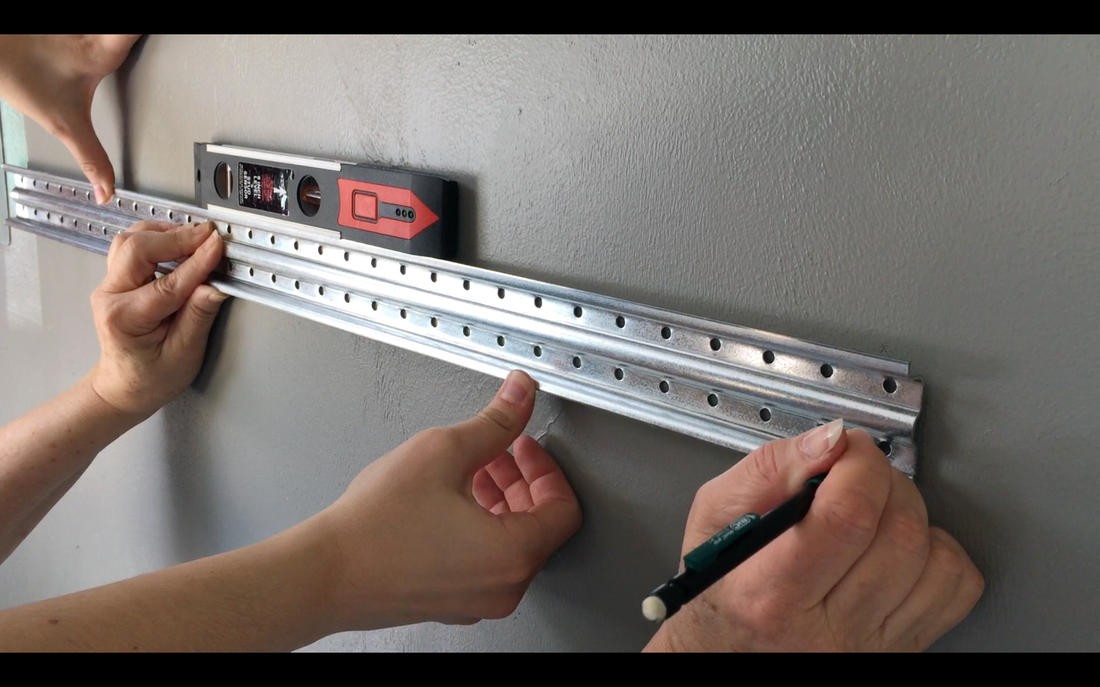Garage organization with Rubbermaid FastTrack.Line up the tracks using a level & mark. MotherDaughterProjects.com