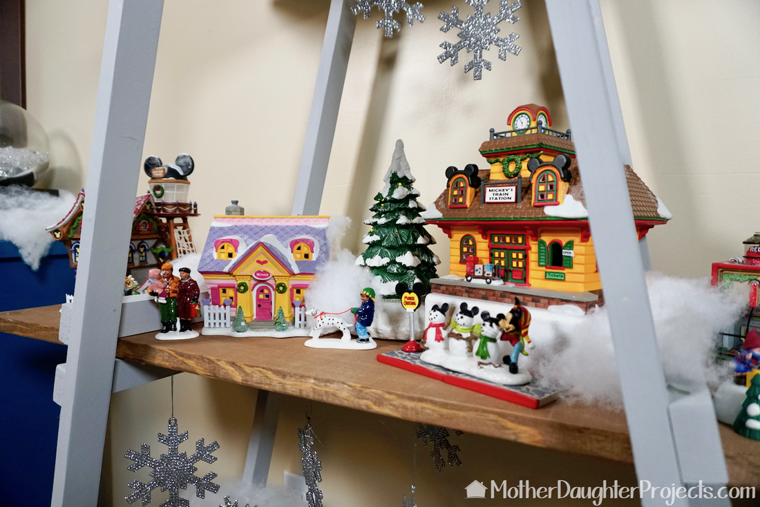 The tree displays Christmas villages and more!