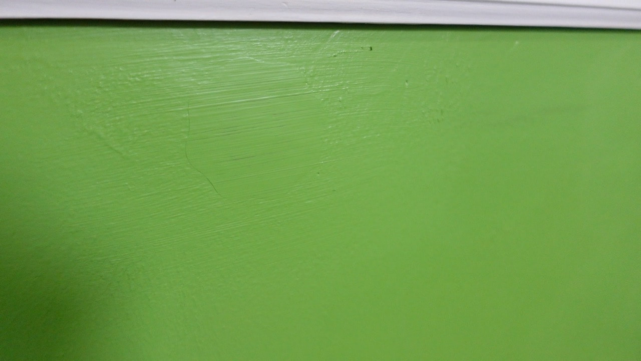 The DAP Eclipse Wall Repair patch is visible on the wall after one coat of paint.