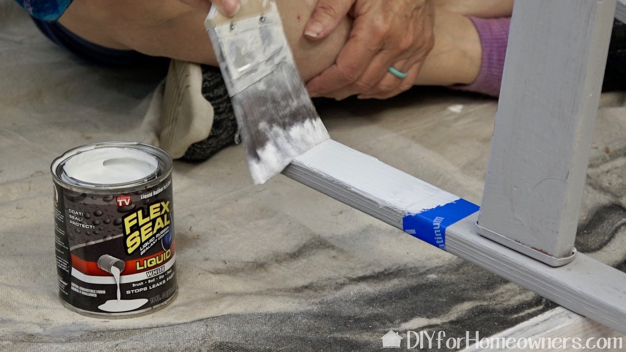 Painting the ladder legs with Flex Seal.