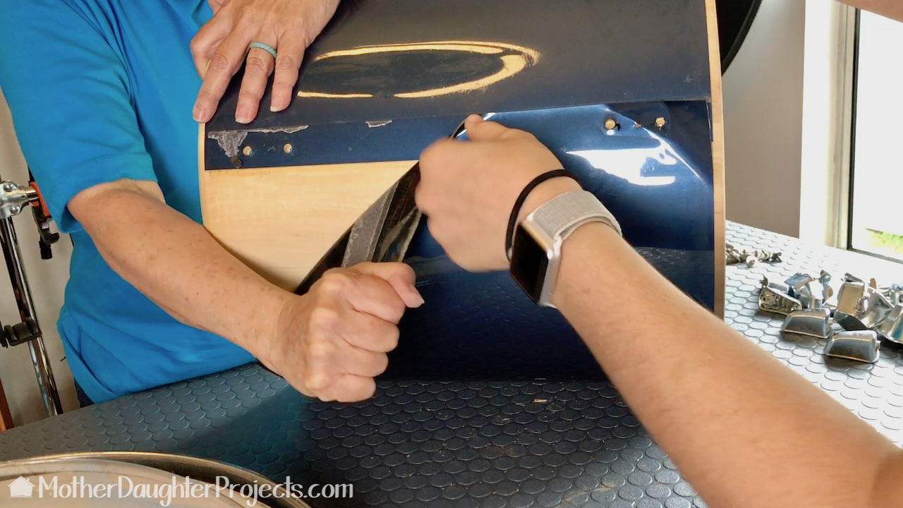 Removing the plastic covering from the drum body.
