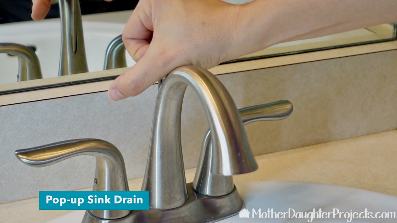 Older sinks have a level at the back of the faucet to control the sink stopper. Time will tell if this pop-up stopper is an improvement over old faucet technology.