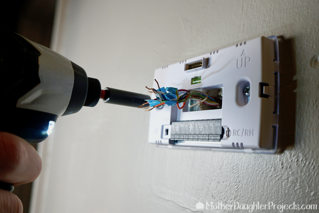 Connecting the sensi thermostat to the wall. 