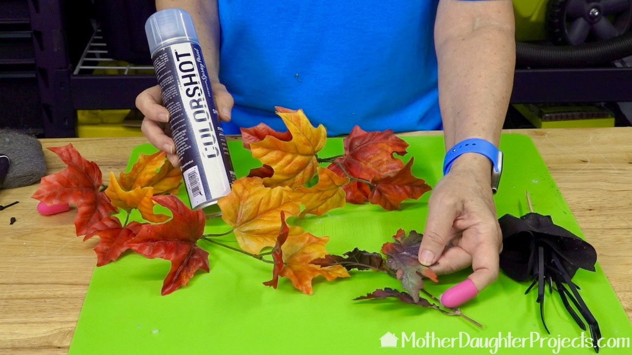 Use fake fall leaves for a little color in your Halloween tree.