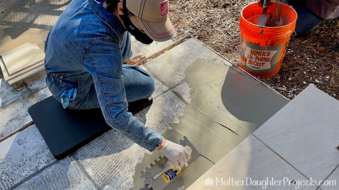 First step is to spread a skim coat of mortar with a notched trowel. 