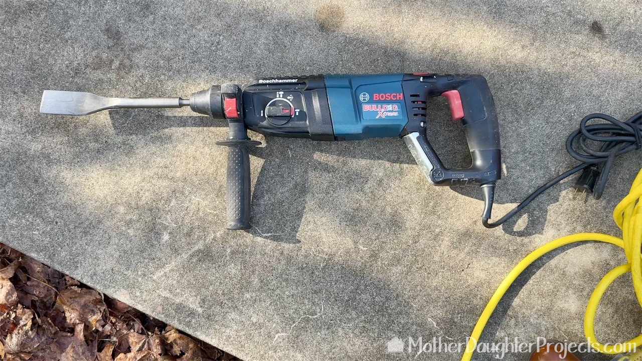 Remove the old mortar with a Bosch rotary hammer drill with chisel blade.
