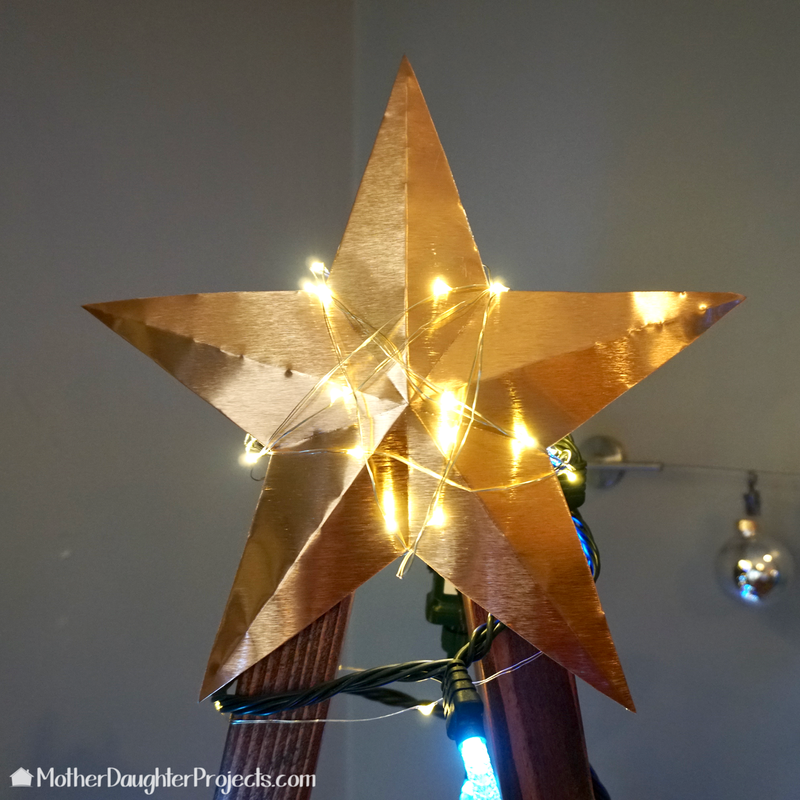 Learn how to use simple 2x4 wood to make this modern and rustic Christmas tree for the holidays. Great for smart Christmas lights, fairy lights and more! All complete with a quikete concrete base.