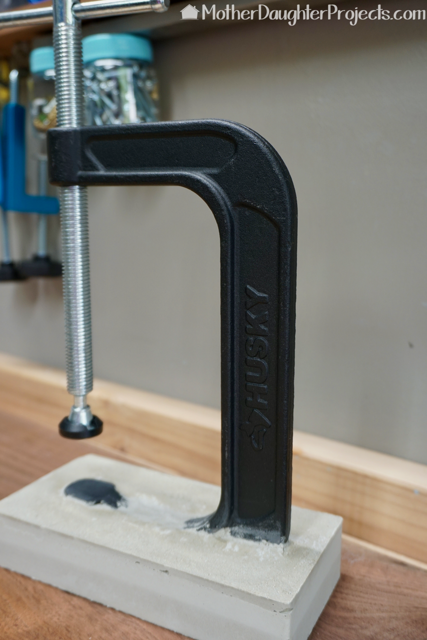 Learn how to use a new or vintage clamp to make a rustic industrial concrete book holder. This book stand would also be great in a workshop to hold tool instructions.