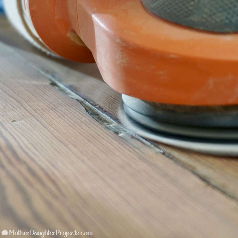 Learn how to refinished a barn wood style dining room table with modern, metal sawhorse legs.