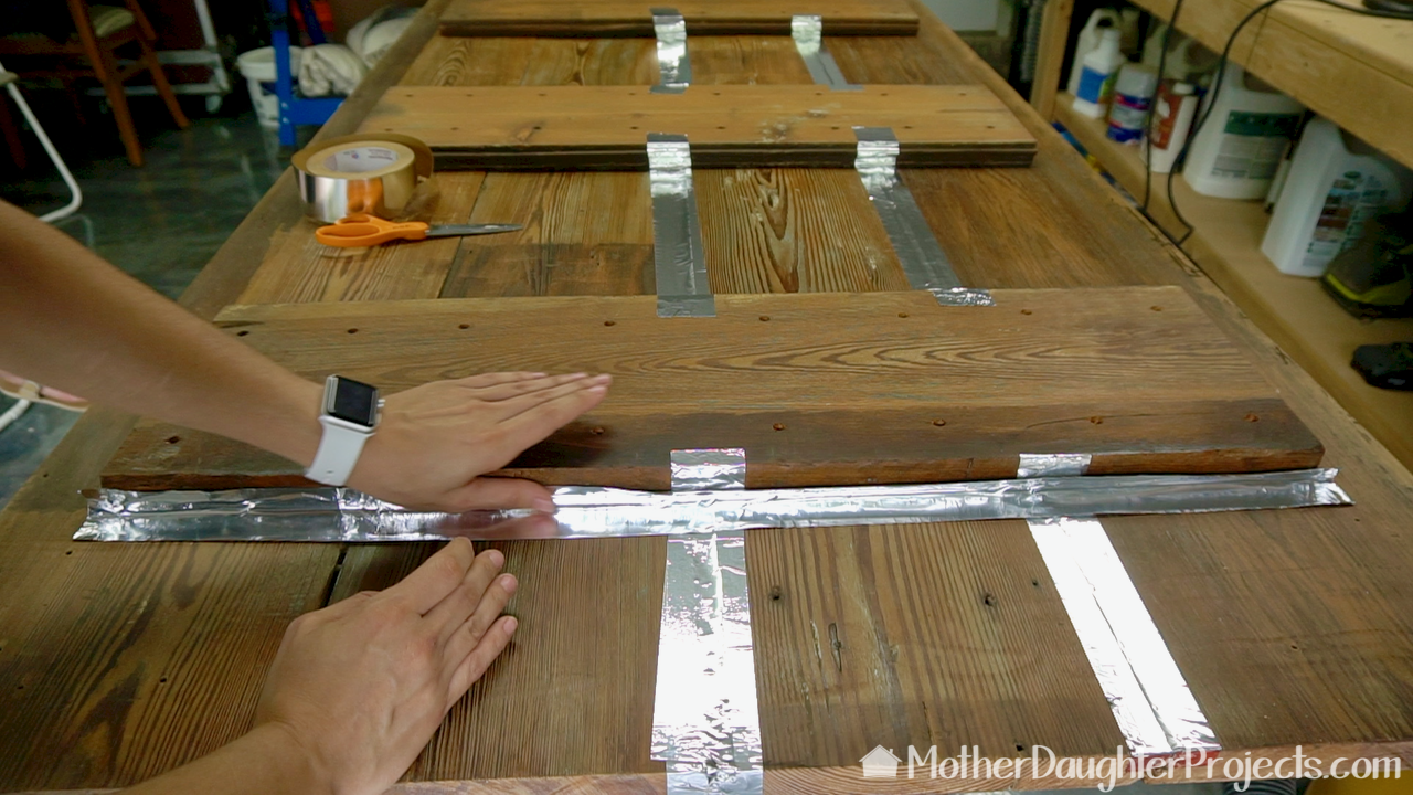 Learn how to refinished a barn wood style dining room table with modern, metal sawhorse legs.