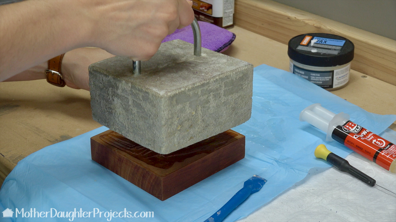 Learn how to use concrete, cement or mortar mix to make a modern door stop. Lego bricks make a perfect mold for this DIY,