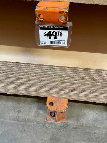 Buying plywood for the wall-hung bathroom cabinet.