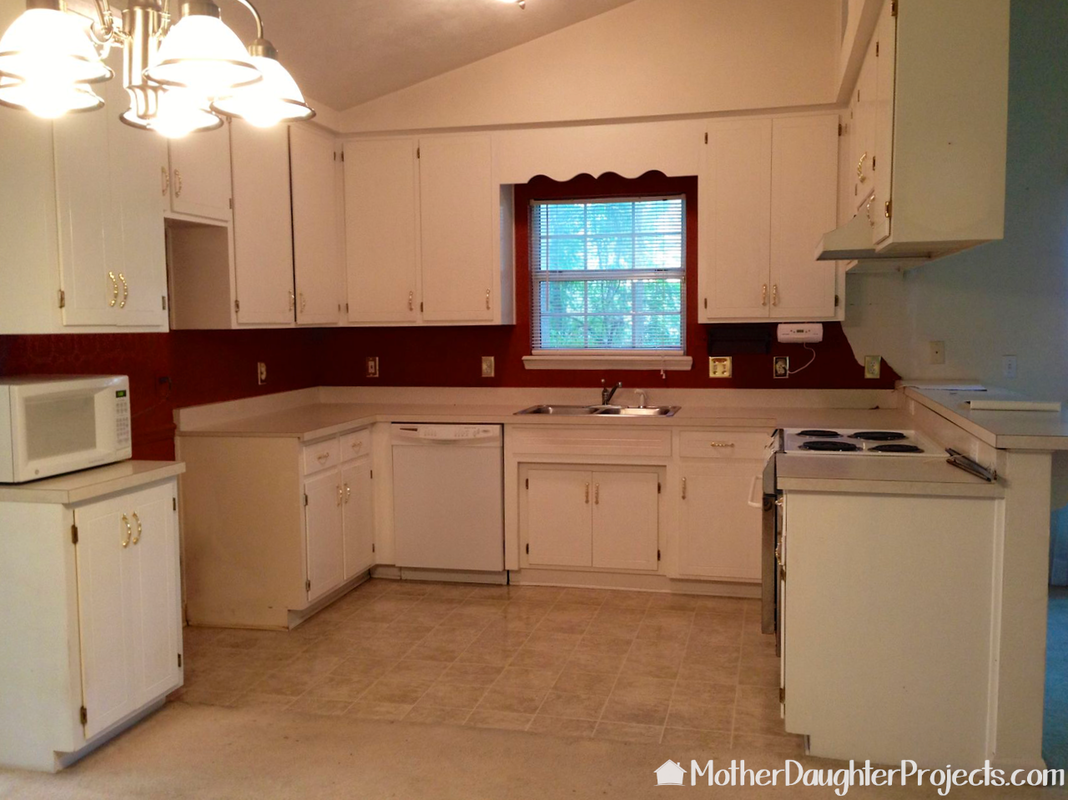 Learn how to do a mini kitchen makeover by painting kitchen cabinets with latex paint, installing a pull out trash can, and installing DIY light fixtures. 