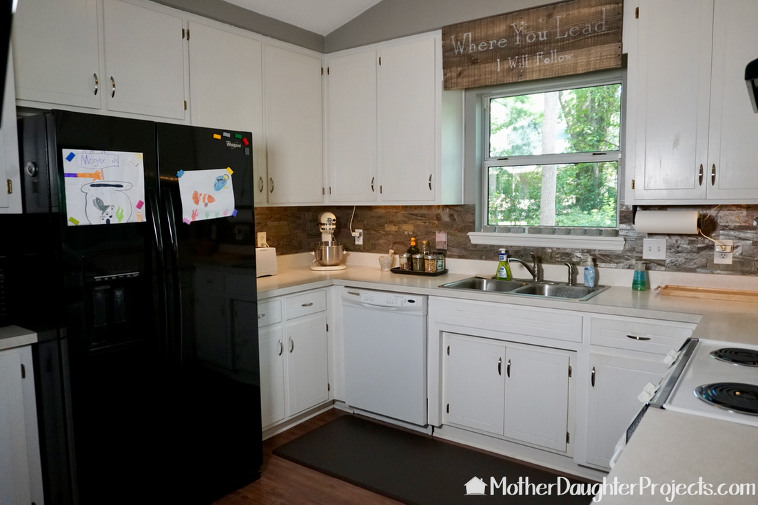 Learn how to do a mini kitchen makeover by painting kitchen cabinets with latex paint, installing a pull out trash can, and installing DIY light fixtures. 