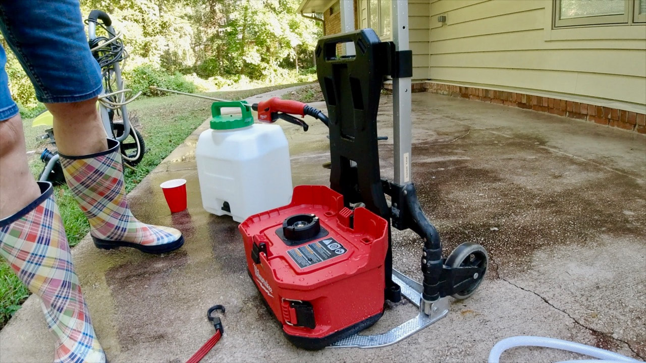 Using the Milwaukee pesticide tank to spray the concrete cleaner onto the patio. 