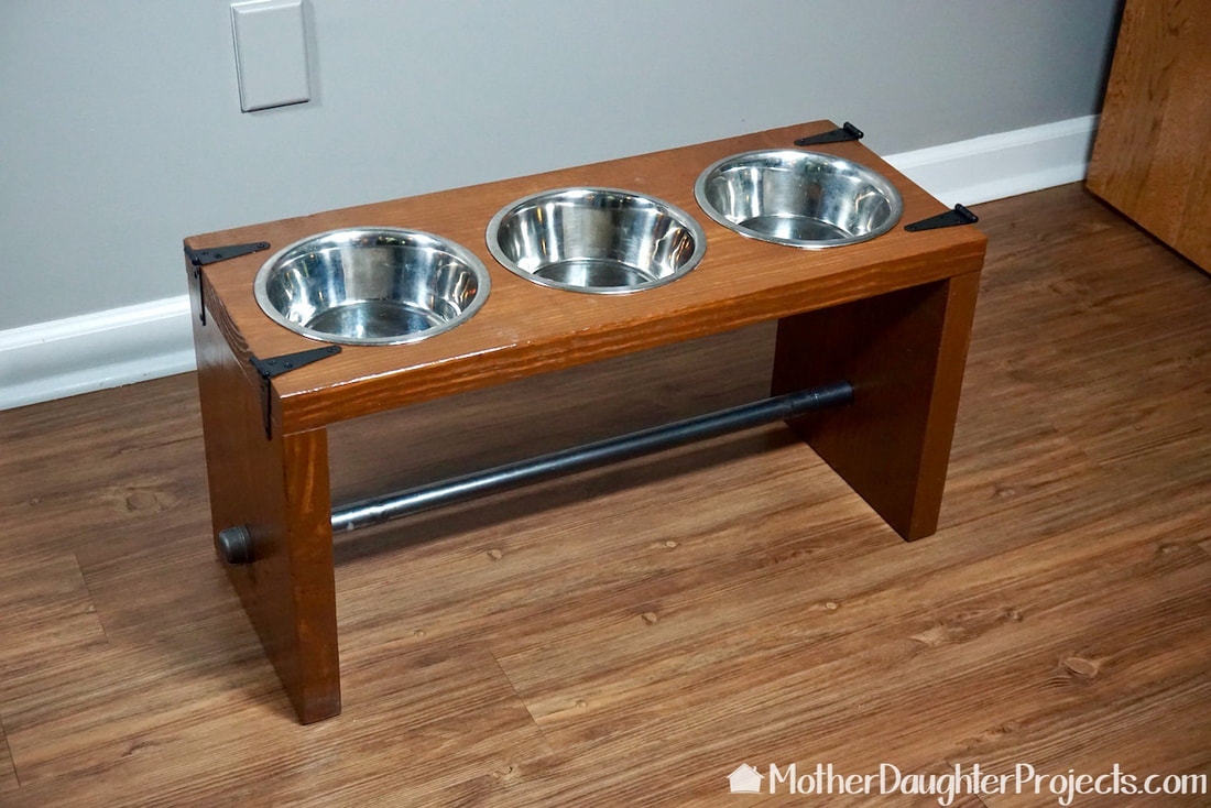 The raised dog bowl stand is ready for two dogs. 