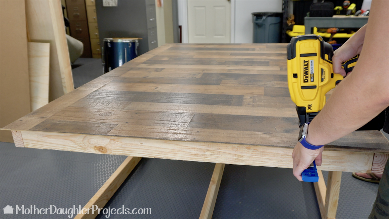 Attaching the pallet panel to one side with the DeWalt brad nailer. 