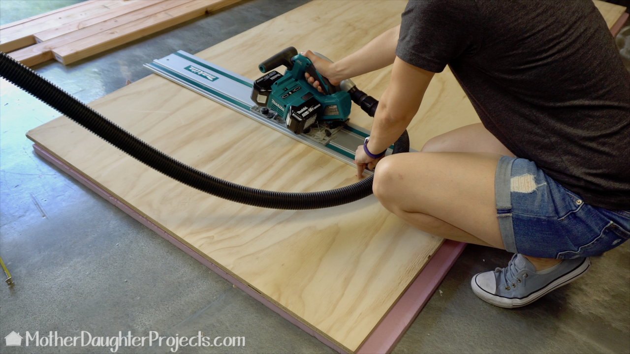 Using the Makita track saw to cut four pieces of plywood. 