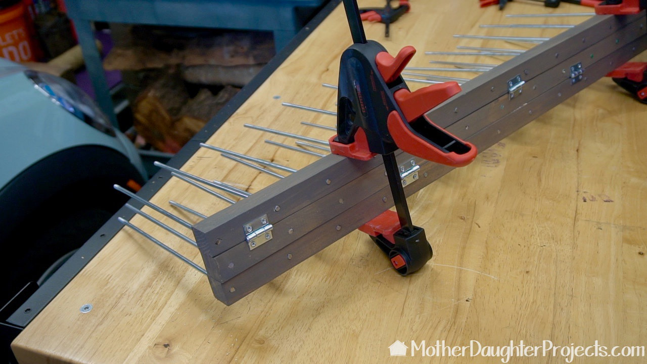 Adding hinges to connect the three wood dowels in the bandana stand. 