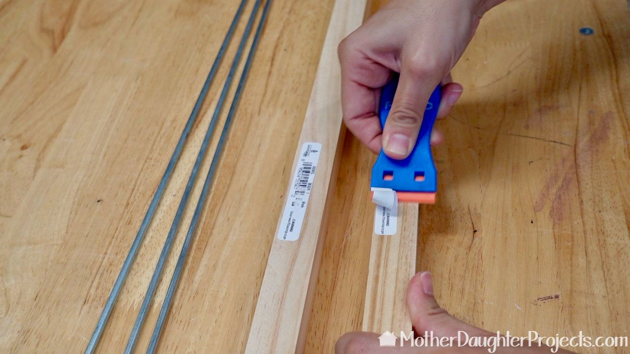 Use a FOSHIO plastic scraper which is available from Amazon to safely remove the stickers from the dowels. 