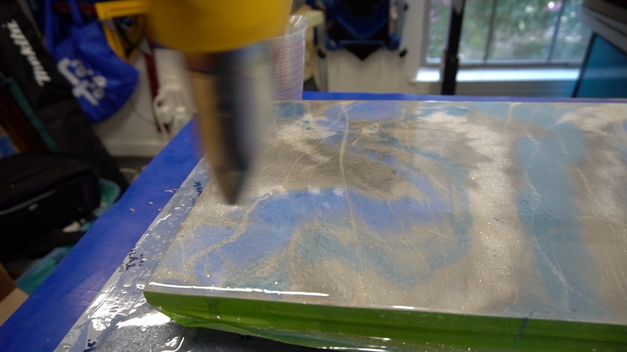 Using a heat gun to get rid of the bubbles in the epoxy.