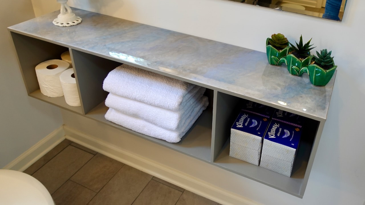 Another look at the bathroom cabinet in the space. There's room for TP, towels, and tissues and the countertop provides space for display.