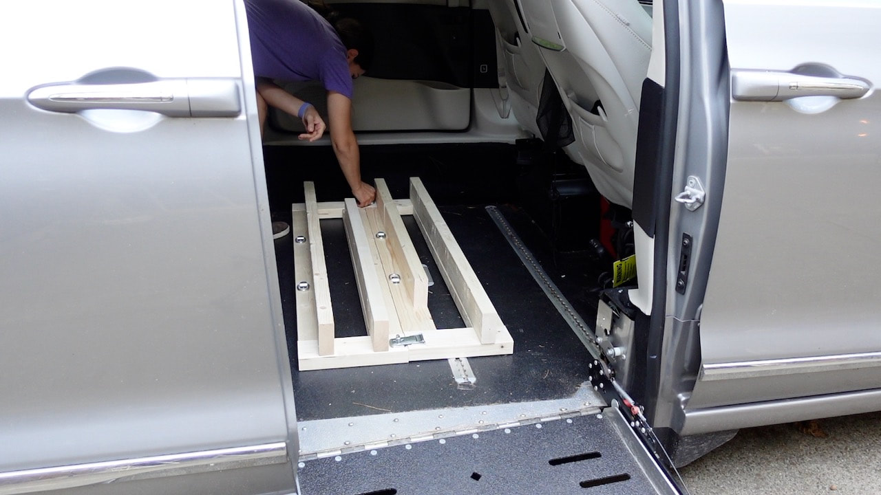 The stand fits into the cargo area of the Chrysler Pacifica modified van with ramp.