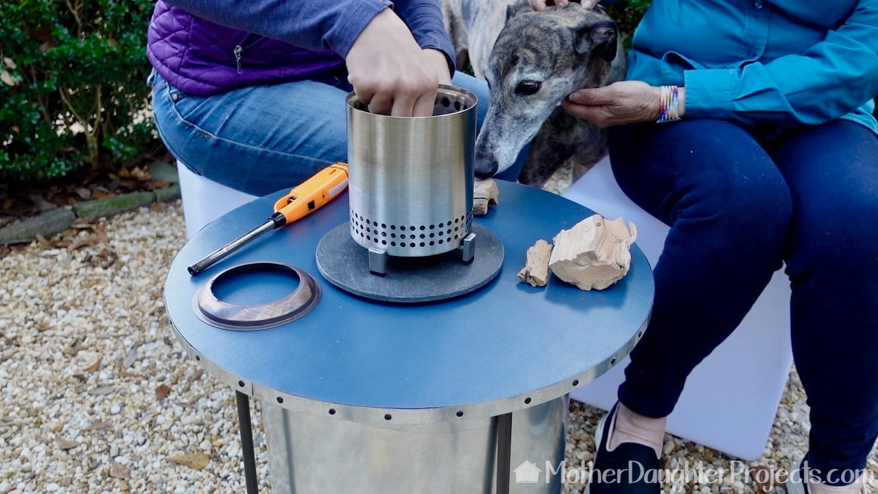Setting up the tiny Solo Stove with the 'help' of greyhound, Tosh! We got our mini wood pieces at The Home Depot.