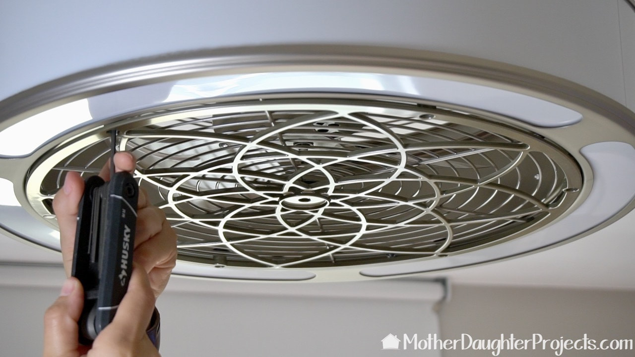 How to clean an enclose fan by first removing the grate or fan cover.