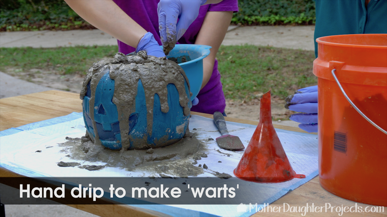 Add drops of concrete to create warts. 