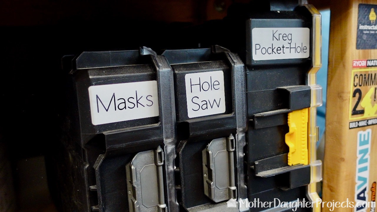 The Cricut cut and written labels add organization to all the storage in the garage. 