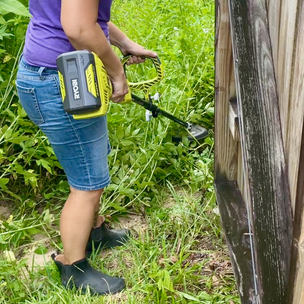 Cutting the weeds at the gate and working our way further into the backyard. 
