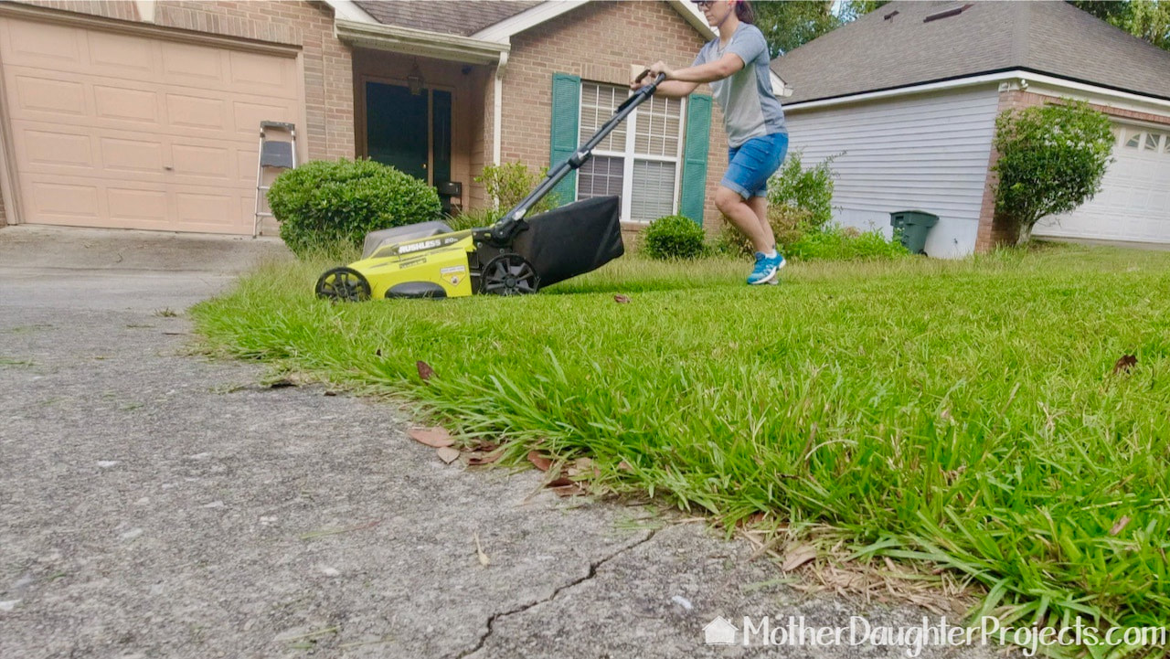 Mowing the yard with the Ryobi battery powered lawn mower. 