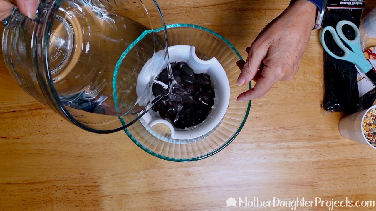 Rinse the vase filler rocks with water to clean them up.