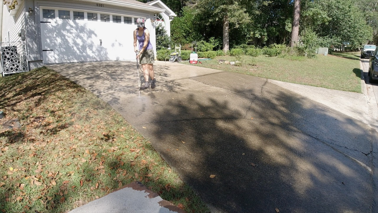 Pressure washing the concrete driveway with the Ryobi electric pressure washer. 