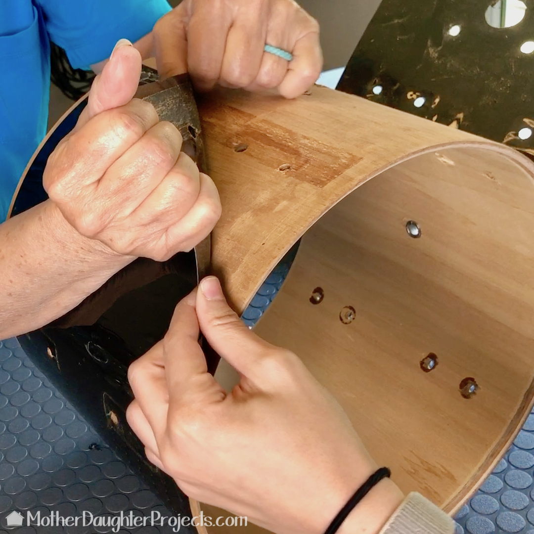 Removing the plastic covering from the outside of the drum.