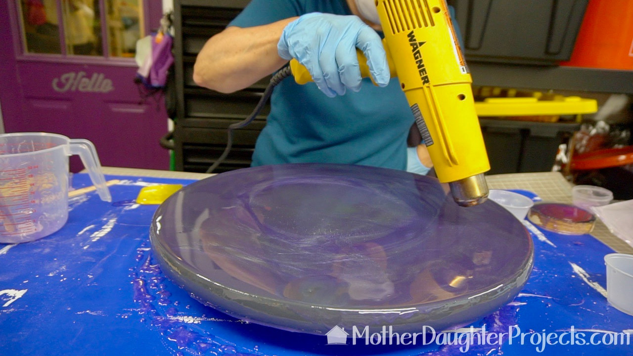 A heat gun gets rid of air bubbles that mar the surface of the finish. 