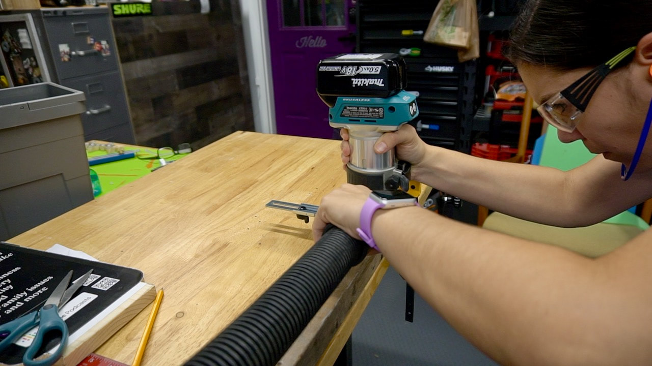 Using a Makita battery powered palm router to create the groove.