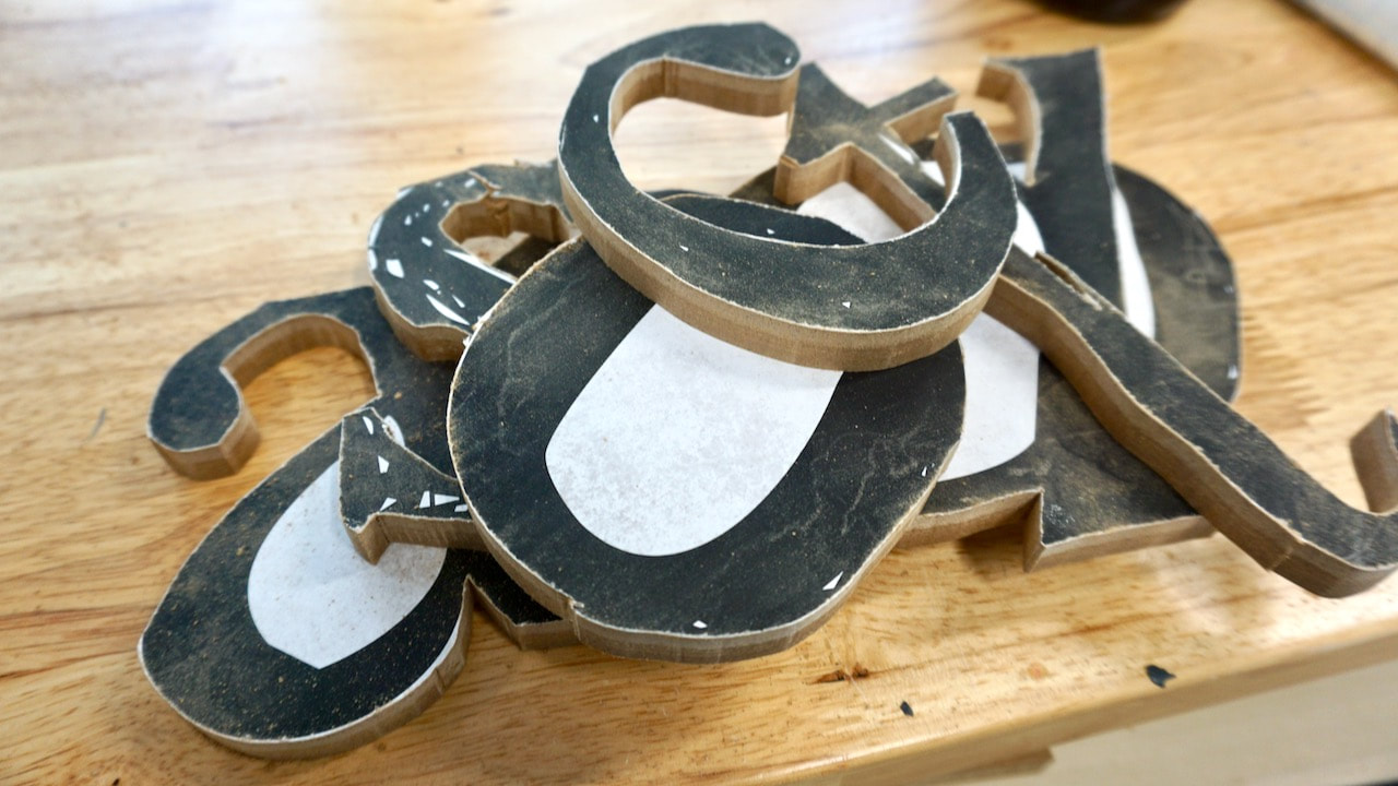 An almost finished pile of scroll saw letters.