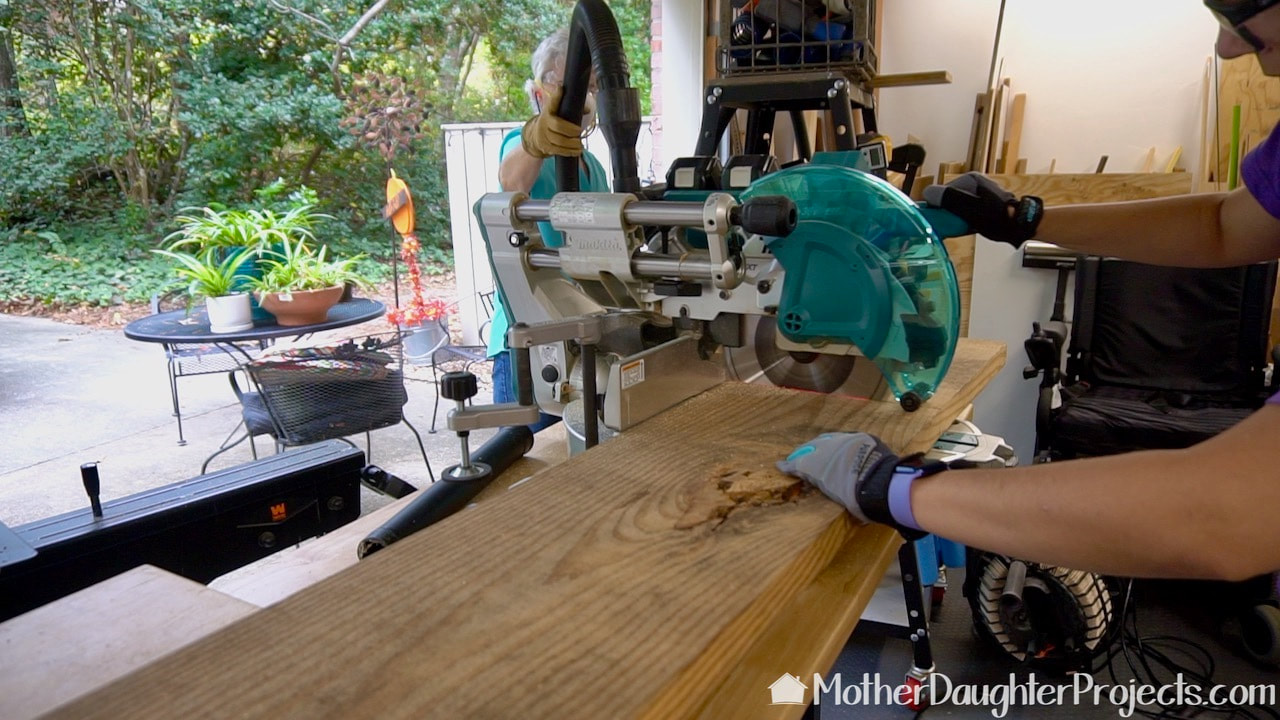 Cutting the faux tabletop to size on a Makita sliding miter saw. 