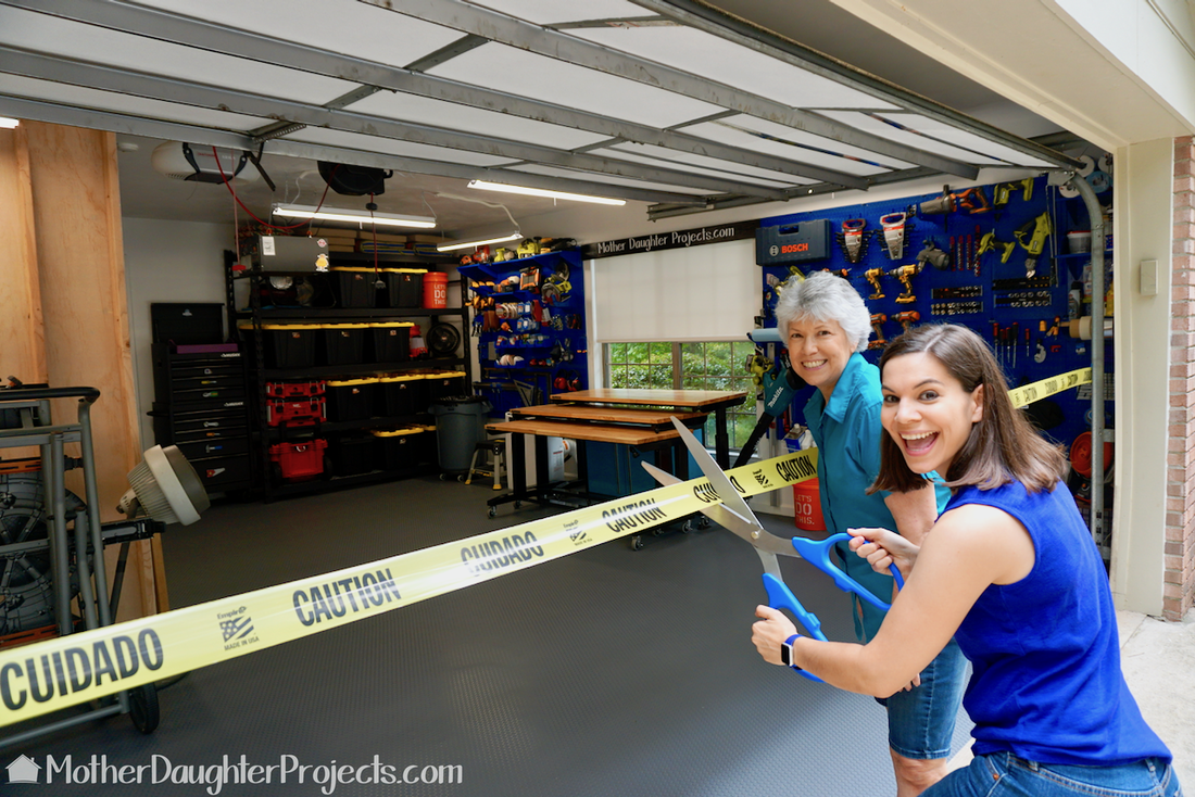 Garage ribbon cutting with giant scissors. 
