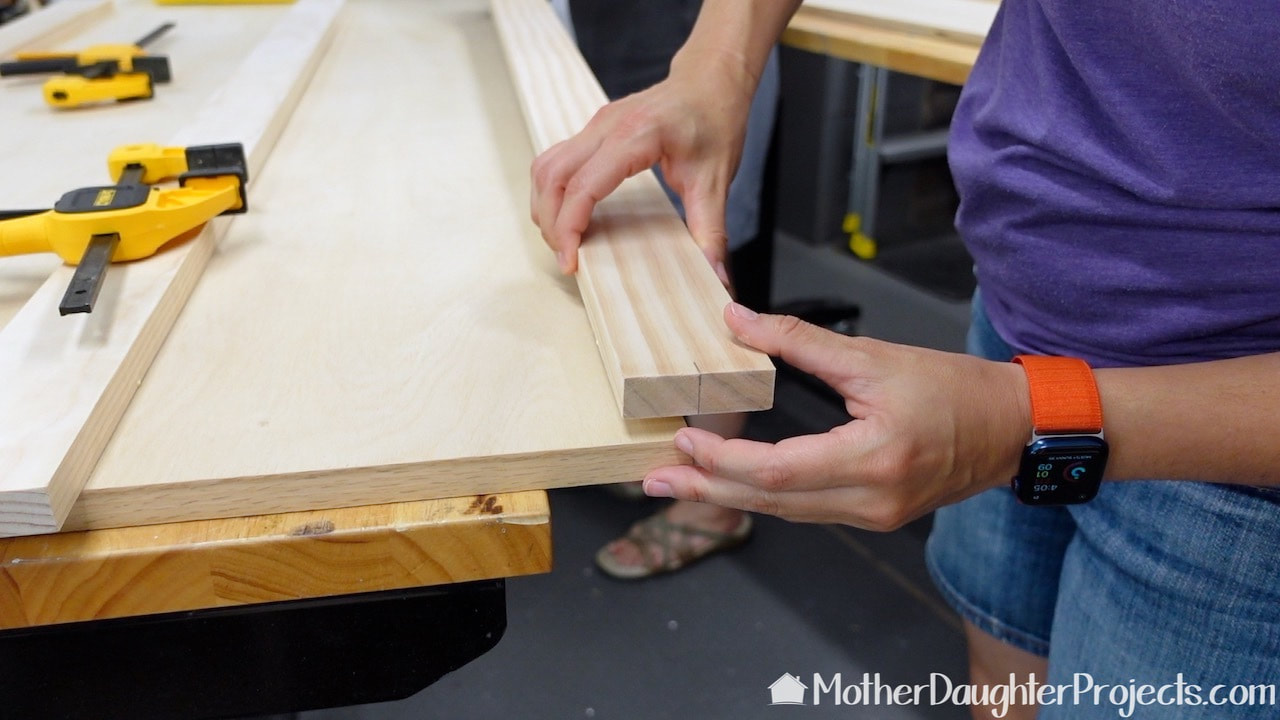 In this image, you can see we are only gluing and brad nailing half of the board to the edge. When put together, the other board will slip behind this one so the seam is hidden.