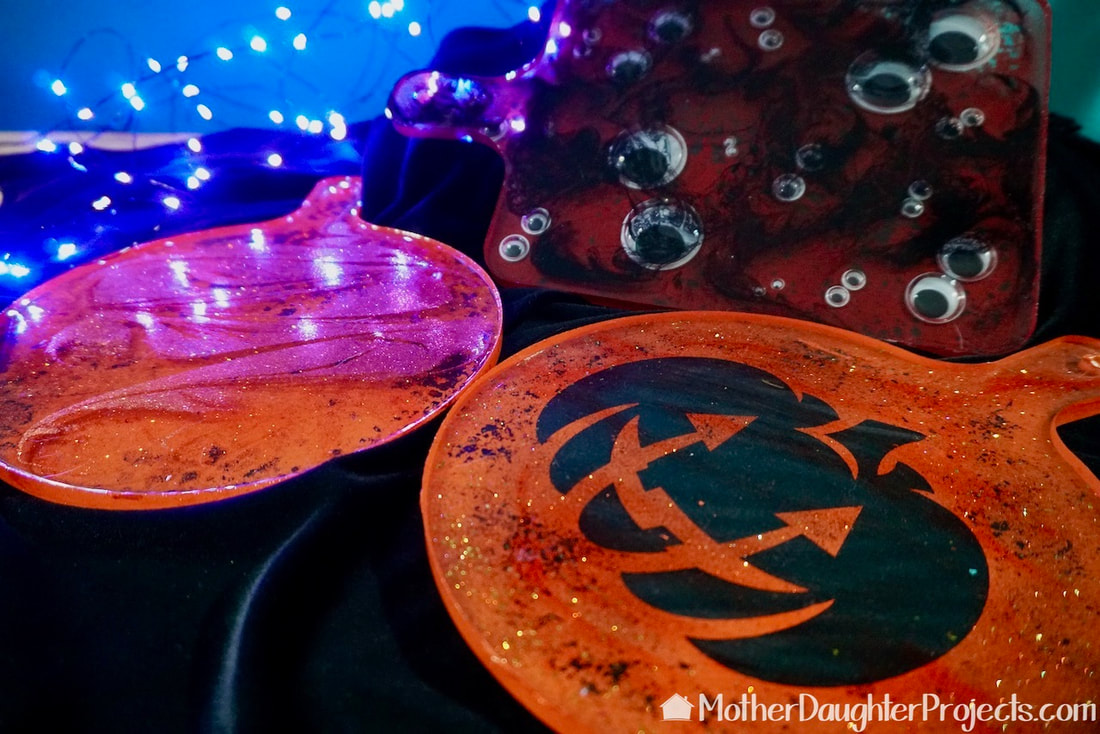 A trio of fall halloween inspired epoxy resin serving trays made with TotalBoat tabletop epoxy and makerpoxy. 