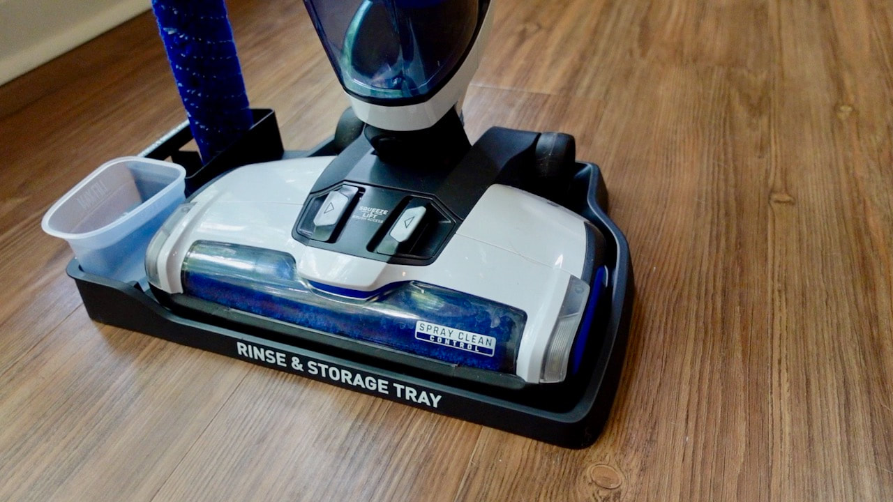 Hoover ONEPWR Cordless FloorMate Jet Hard Floor Cleaner, Wet Vacuum sitting in the rinse and storage tray.