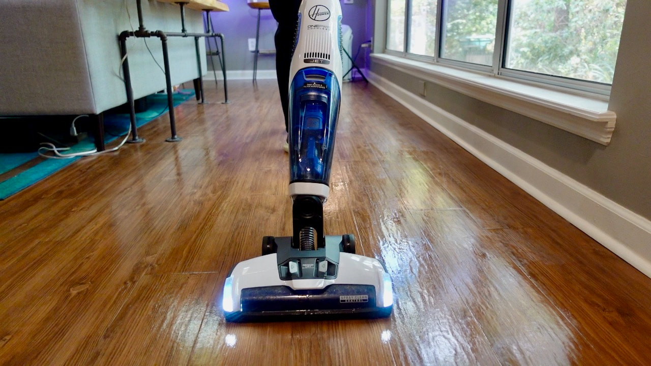 The trigger on the handle sprays the solution, the roller scrubs and the vacuum picks up excess water. 