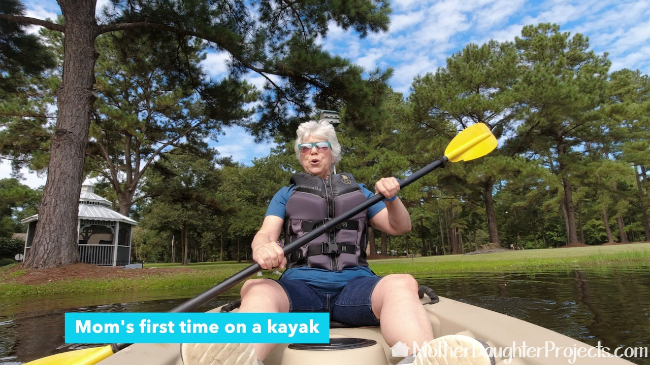 Vicki taking the kayak out of the lake on her own.