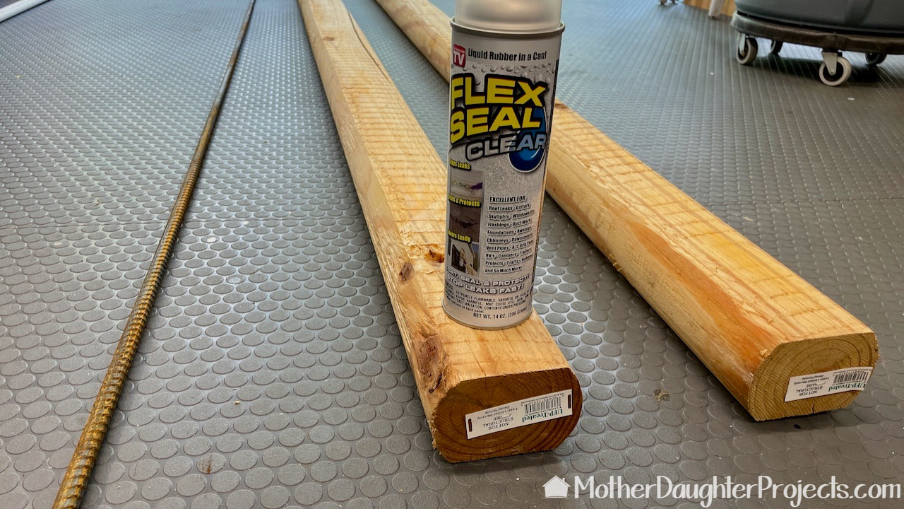 We're using landscape timbers, rebar, paint, and Flexseal sealant to build the kayak stand.