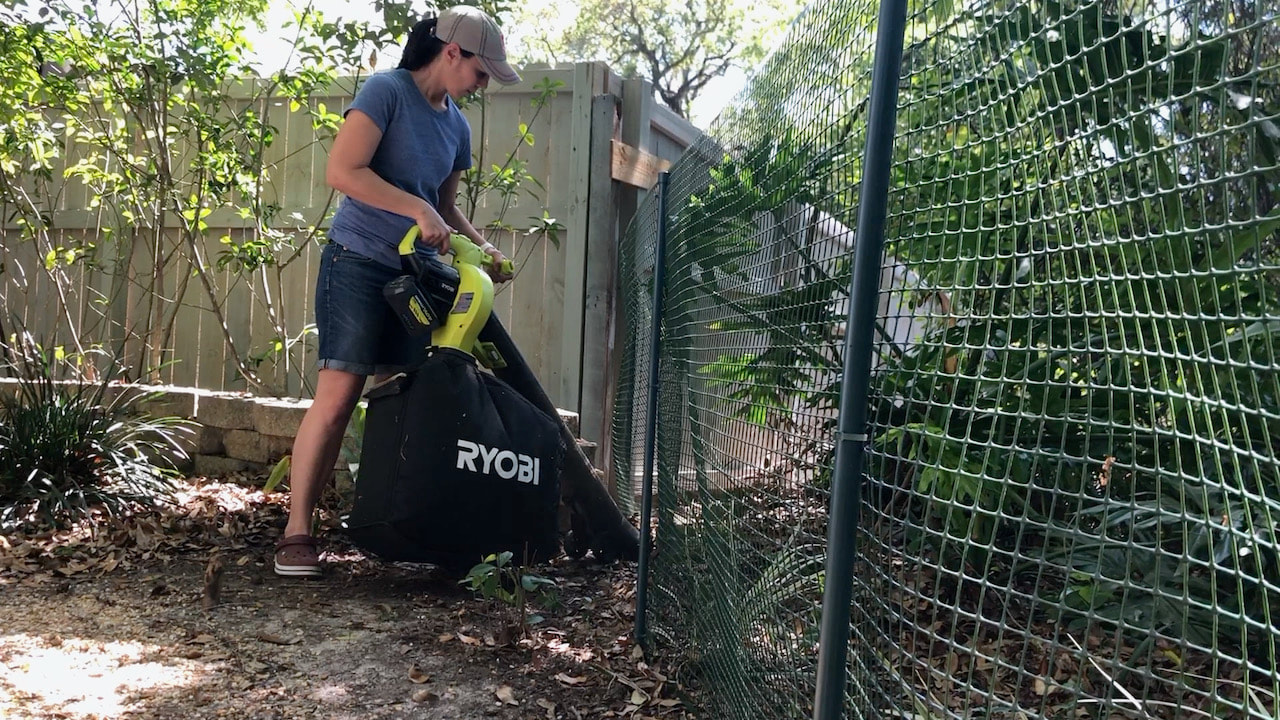 The Ryobi battery powered leaf vacuum in use in Steph's backyard.