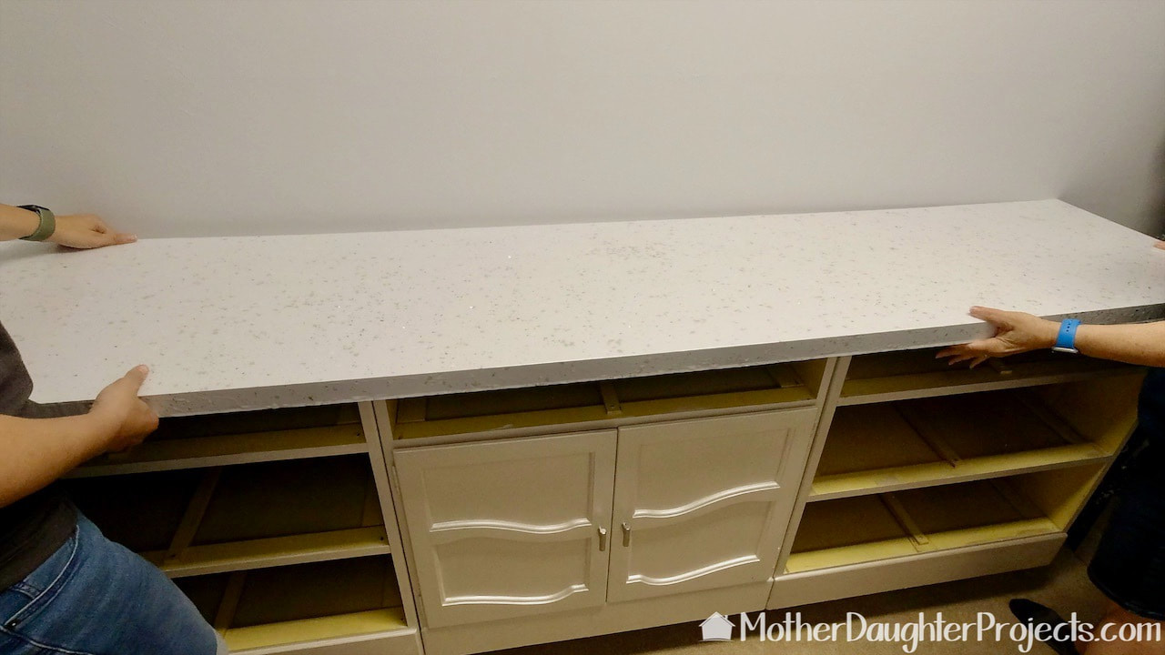 With the six inch riser in place, we put the cabinets and countertop back into place.