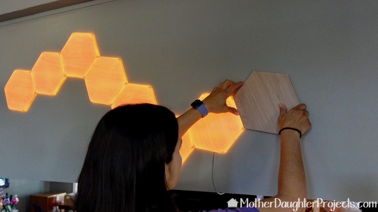 Applying the Nanoleaf elements in place on the wall.